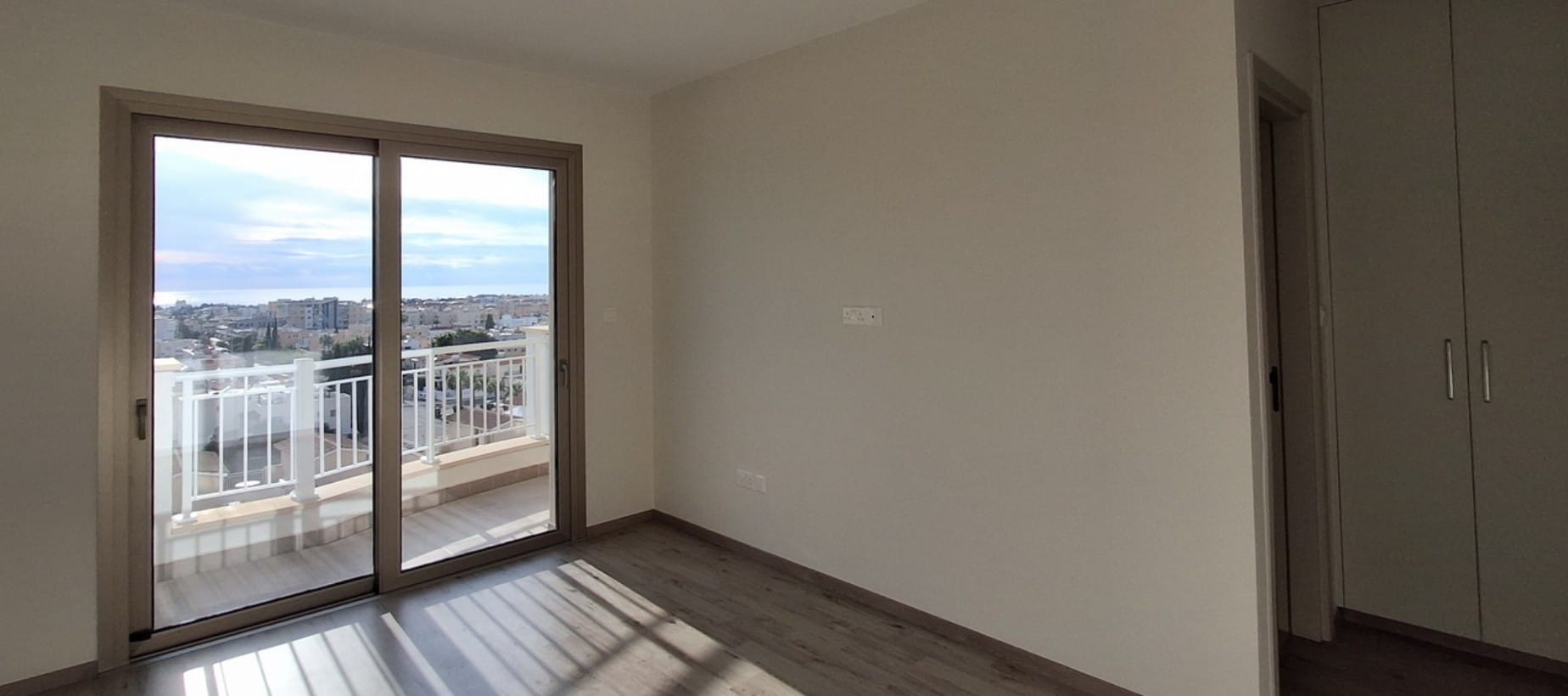 Bedroom with balcony access in a Central Paphos apartment