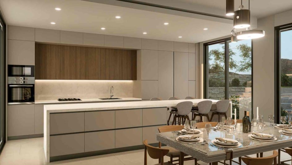 Modern fitted kitchen with central island, breakfast seating and dining table beside full-height windows