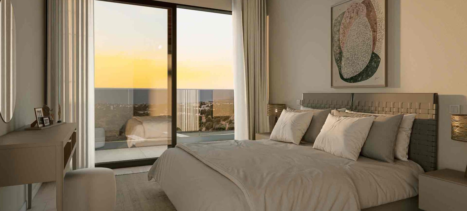 Bedroom with sliding glass doors opening onto a balcony with views towards the sea at sunset