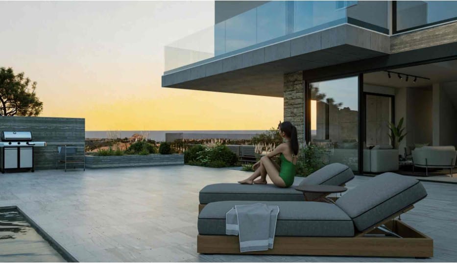 Poolside terrace with sun loungers and BBQ area overlooking the sea at sunset