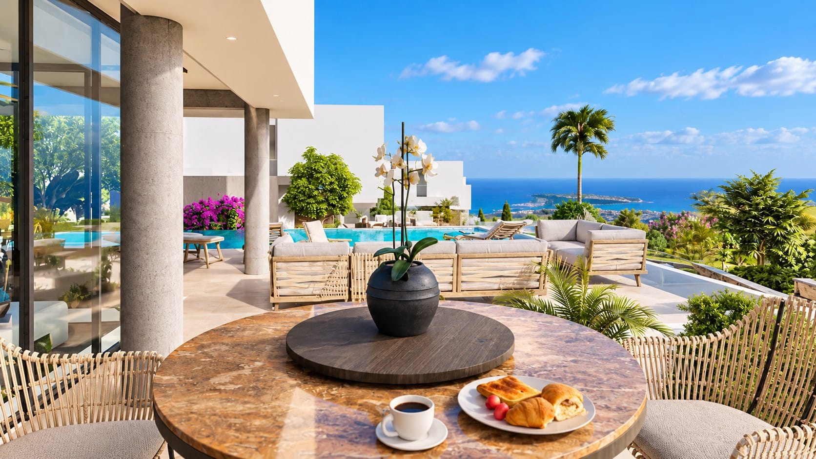 Covered terrace with outdoor dining table and lounge seating beside a swimming pool, overlooking the Mediterranean Sea and coastline